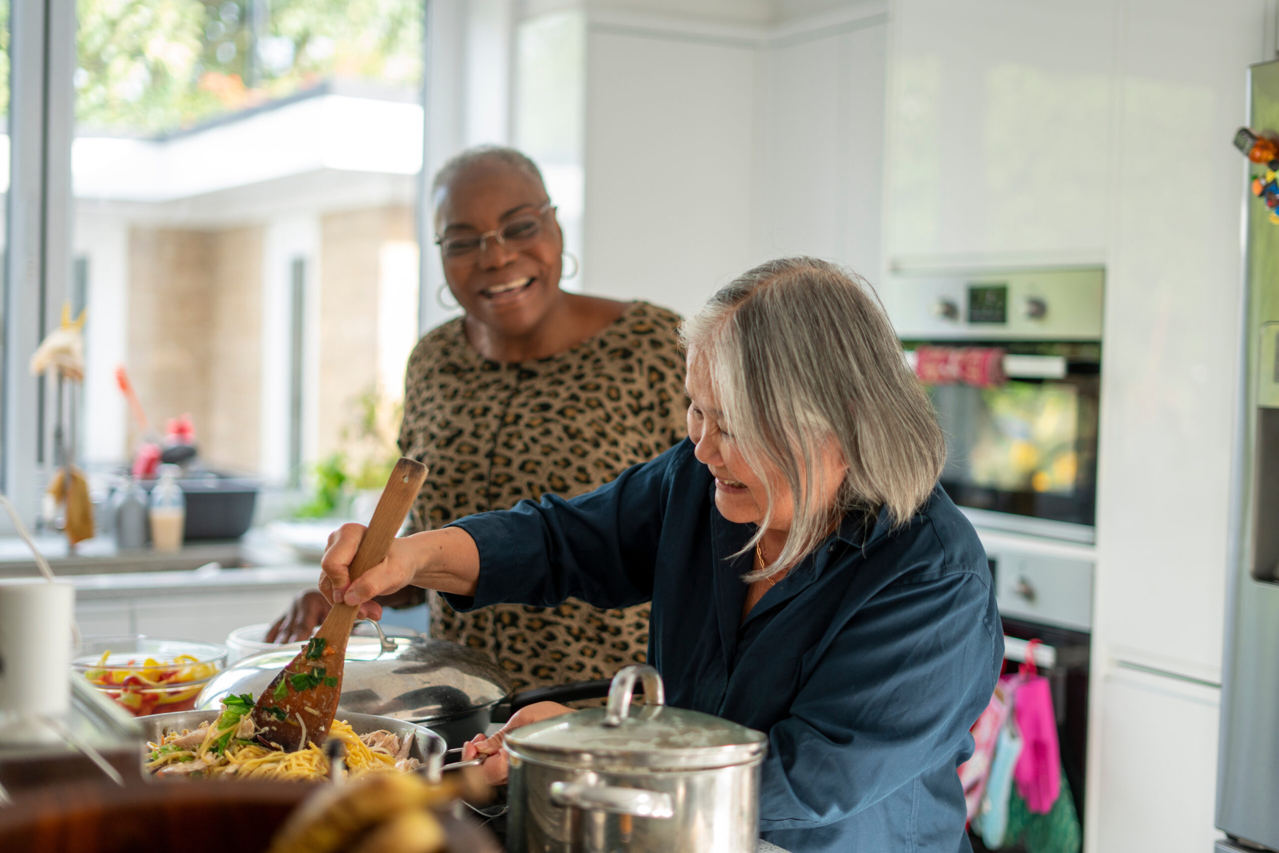 Two people prepare dinner in their new CLT home.