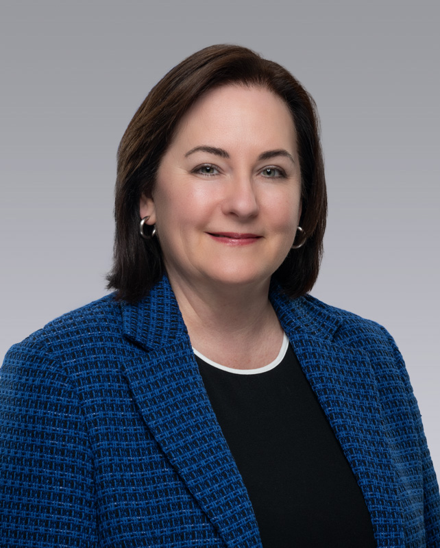 Headshot of Monica Morgan, a woman in a blue blazer.